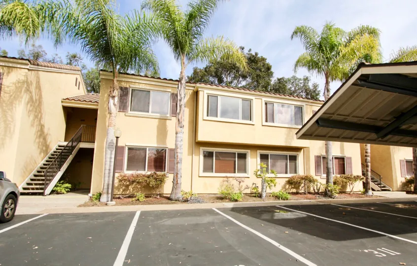 Two story buildings with palm trees & stars inside the Villa Tuscana in La Jolla CA