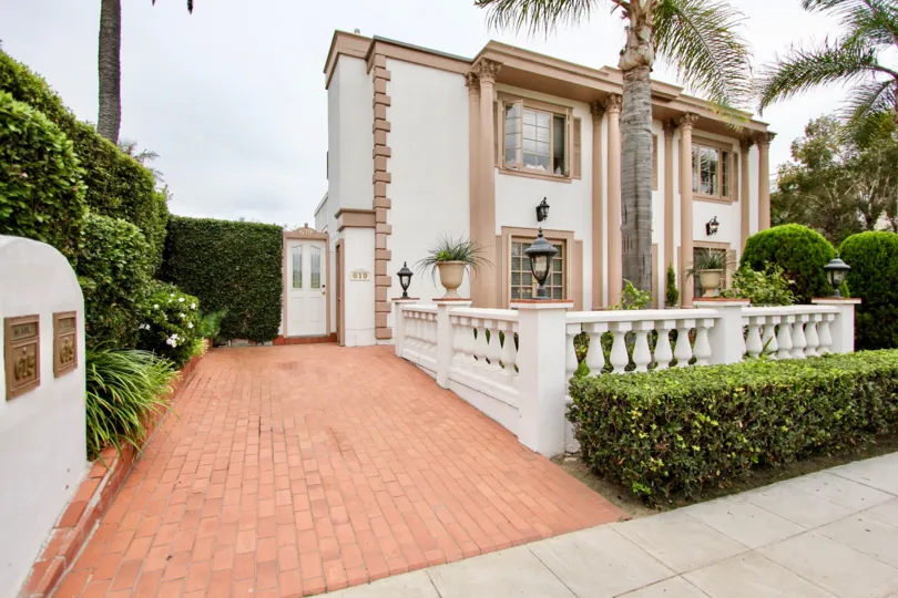 pink brick walkway near residence & palm inside village chateau in la jolla california