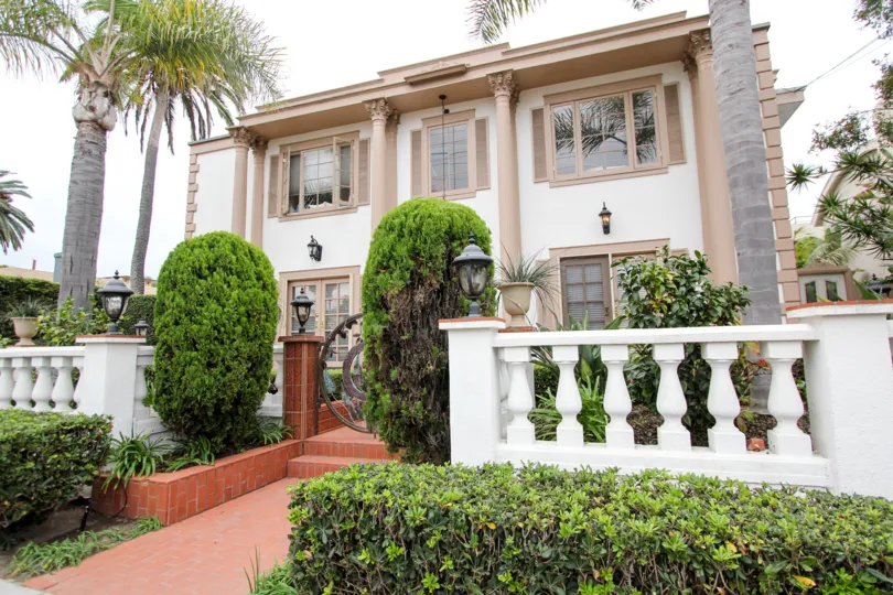 Two story home with brown roman style pillars in Village Chateau at La Jolla CA