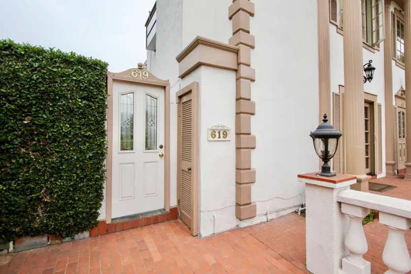 Large white building with brown trim & lamp in Village Chateau in La Jolla CA