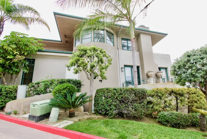 a beautiful home that covered with green garden in community of village point