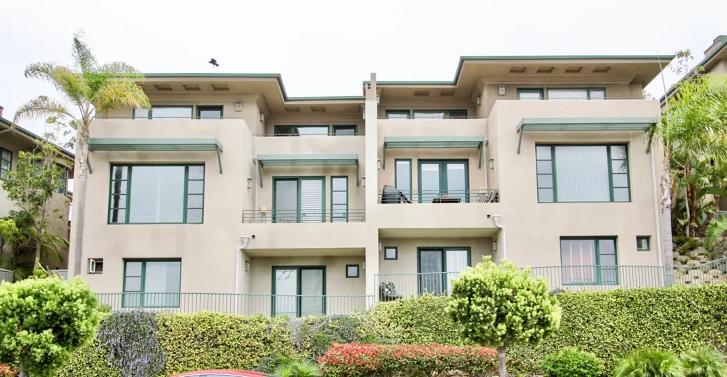 The apartments in the Village point with garden in front the village point has bushes and trees