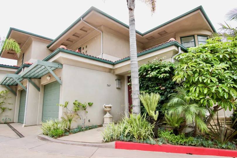 A BEAUTIFUL HOME THAT HAVE GREEN AND CREAM COLOR PAINT IN THE COMMUNITY OF VILLAGE POINT