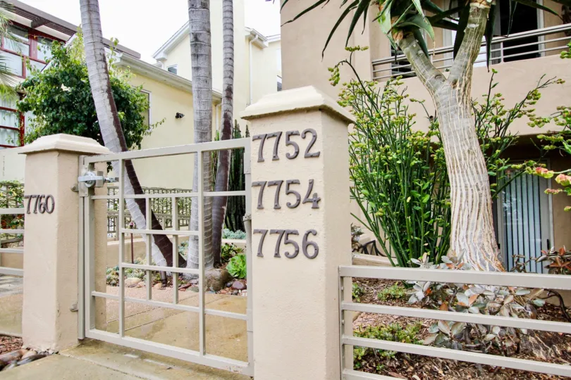 Gateway entrance with multiple address numbers at Village Walk in La Jolla CA