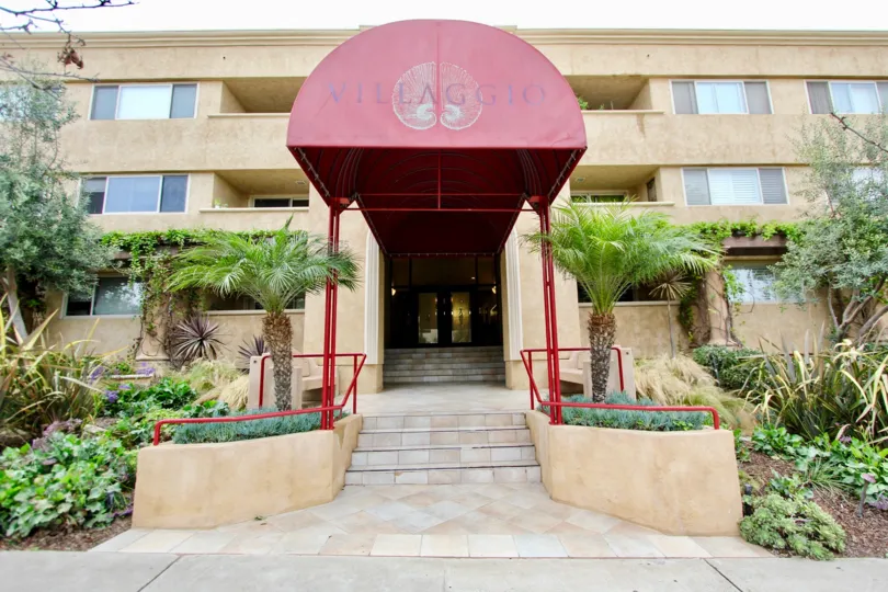 The front view of a house with gardens in Villaggio of La Jolla