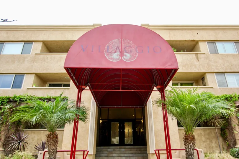 In the Coverage to the parkway of Villaggio has red color shield and has plants on both sides