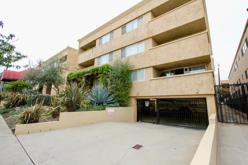 A sunny day in the Villaggio with residential apartment and plants.
