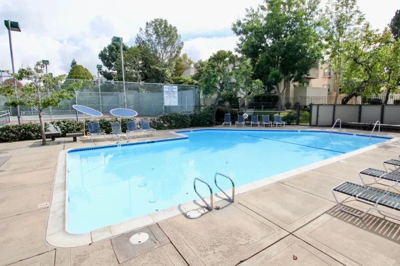 Woodlands West I pool and tennis court with chairs La Jolla California