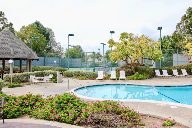 The pool area with tennis court in the Woodlands West ll community of La Jolla, California.
