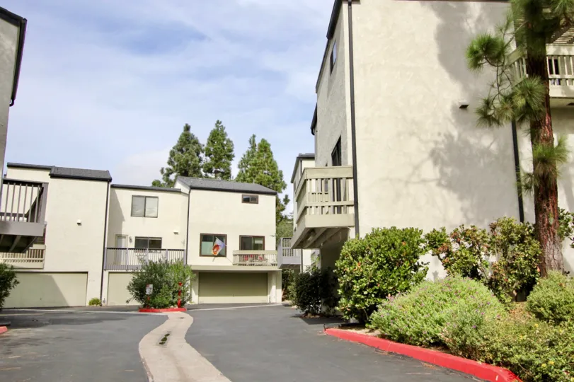 Three story gray roof housing near driveway at Woodlands in La Jolla California