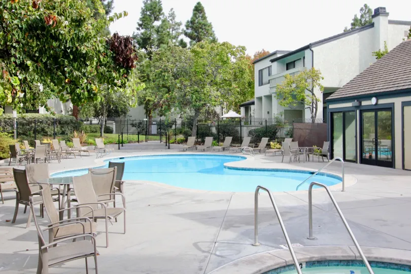 Large swimming area with lawn chairs inside Woodlands in La Jolla California