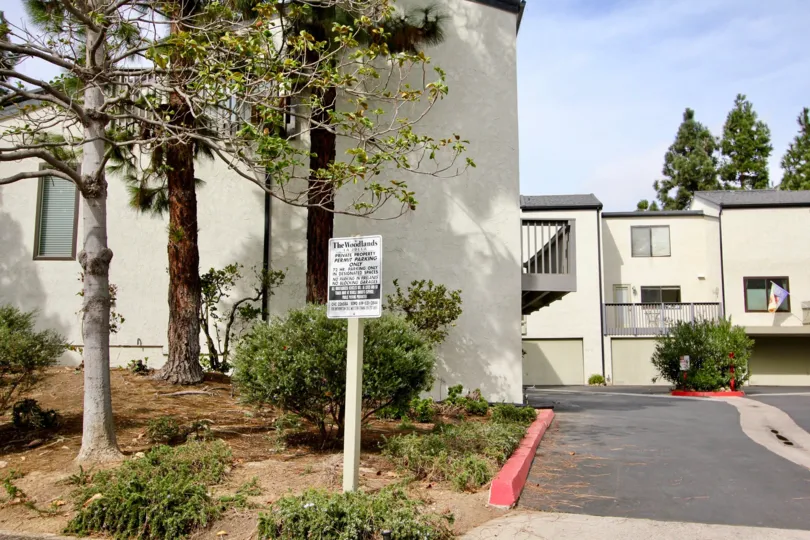 Beautiful treed area with clean property and bright skies.