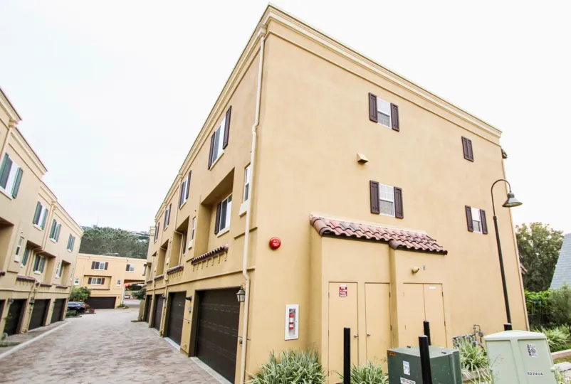 THE BUILDING IN THE ZIANI WITH THE SHUTTERS, PLANT, TREE, ELECTRONIC BOX