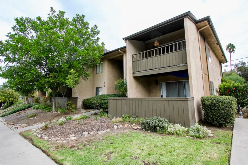 Two story town homes with large brown fenced in patios at Brierwood Village in La Mesa CA