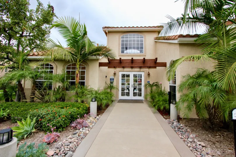the front entrance of the Central Park La Mesa with number of plants on both sides of entrance