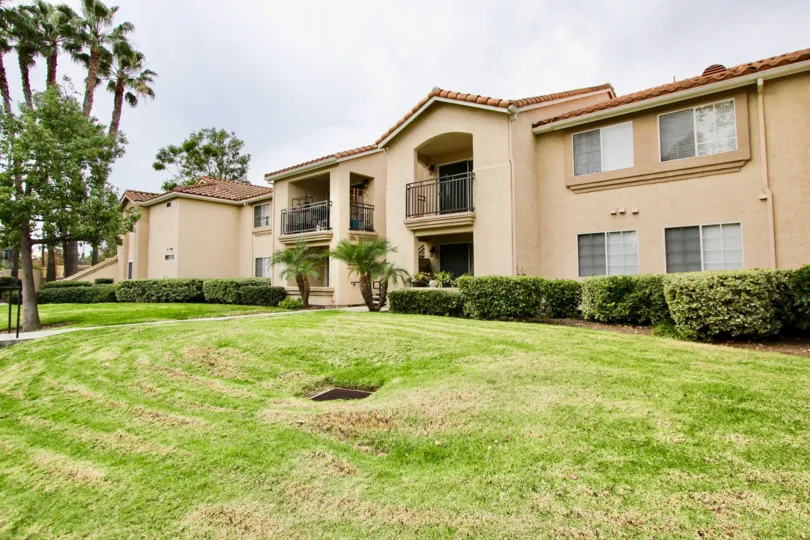 THE VILLAS IN THE CENTRAL PARK LA MESA WITH THE GRASSLAND, TREES, PLANTS, BALCONIS