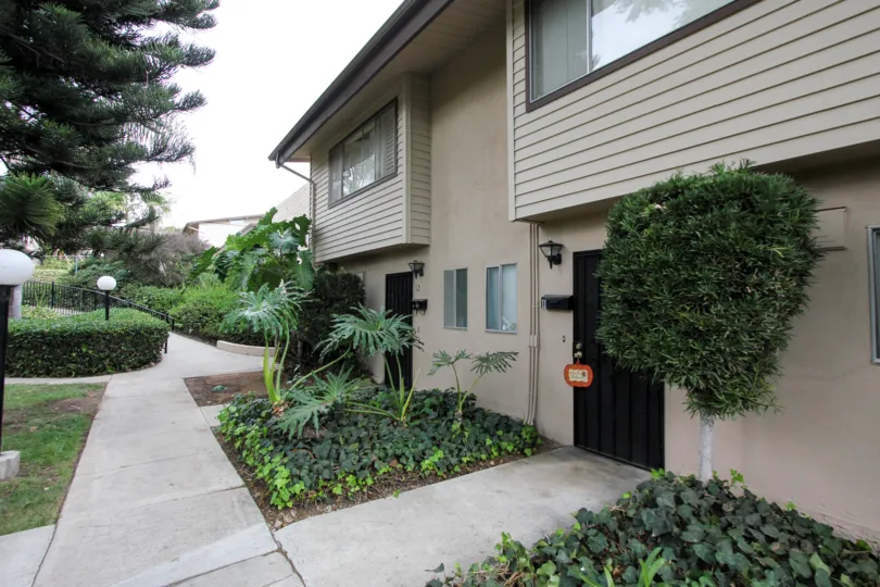a pleasant day in the grossmont village with a building that has garden attached with a and clossed in steel doors