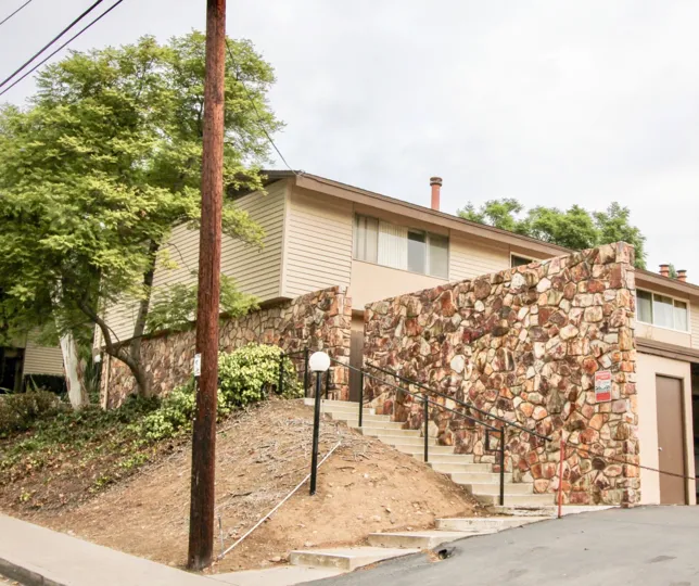 THIS IMAGE SHOWS THAT HOUSE WITH THE GROSSMONT VILLAGE WITH THE UPSTAIRS, TREES, PLANTS