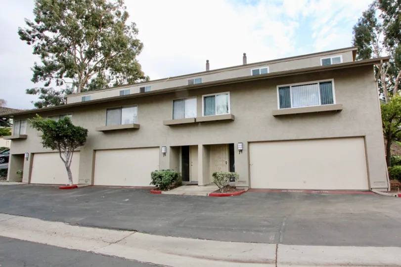 the La Mesa Racquet & Swim Club is wide and small plants in the front side