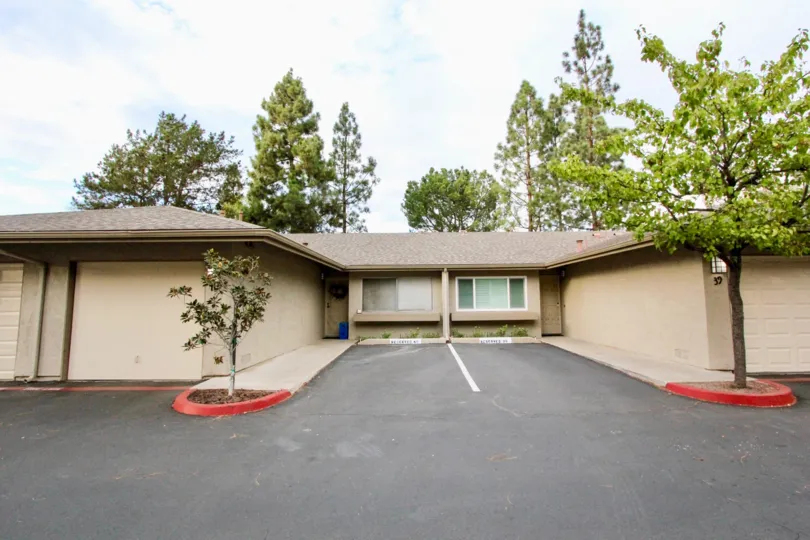 the La Mesa Racquet & Swim Club is wide and small plants in the front side