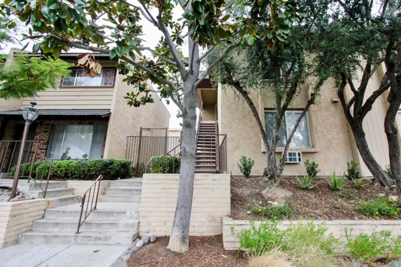 a warm day in the la mesa village with a building which has common steps for two different houses in it