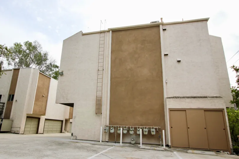 A large brown & white condominiums with gas meters inside the Marengo Court in La Mesa CA
