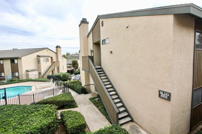 In BLDG 800 apartment with swimming pool with chairs and bushes in Parkway Manor