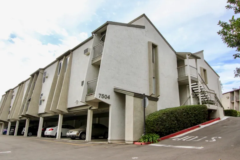 a warm day in the parkway pointe with a building that has parking at its ground floor and numbered as 7504