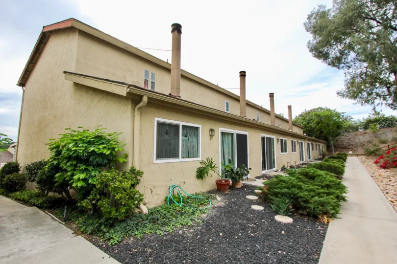 a pleasant day in the parkway villas with a lenghty building which has glass door and windows