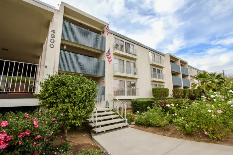 A walkway leading to brown cement steps and cement railings at Rosehedge Manor in La Mesa CA