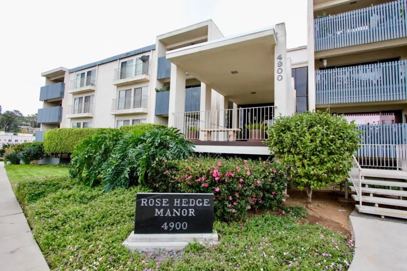 A sunny day in the area of Rosehedge Manor, outside, condos, flowers, bushes, balcony, gate