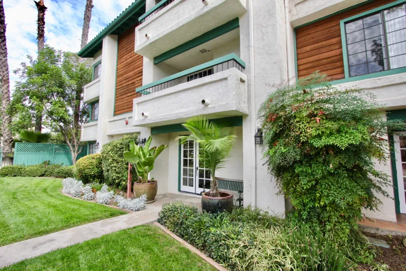 Beautiful Villa with a balcony and lawn with trees in front in Shasta Greens of La Mesa