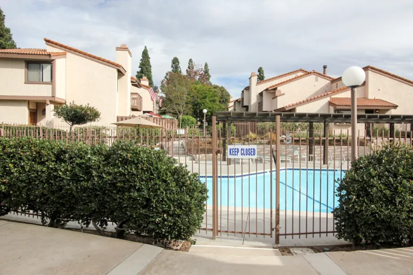 The The Woodlands with the front gates closed and a swimming pool inside