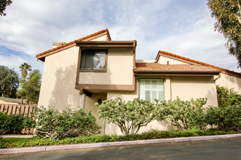 a warm day in the woodlands with a house that has no roof top and also has plant in the sides