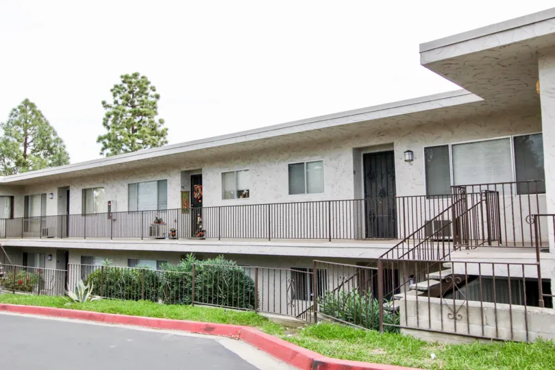 A red curb in front of a two story housing building inside Villa Del Sur at La Mesa CA