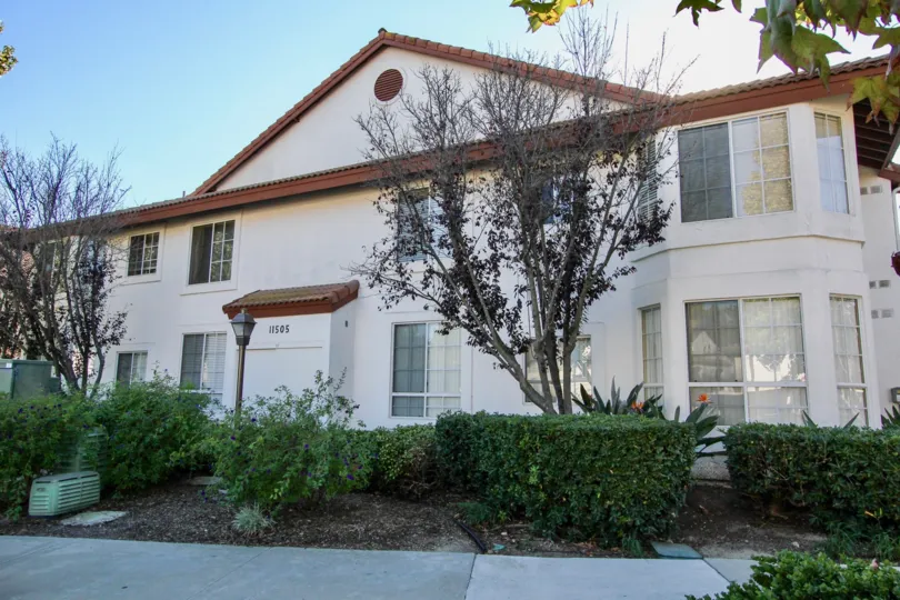 Red tile roof with shiny window and nicely groom garden in Canyon Bluffs