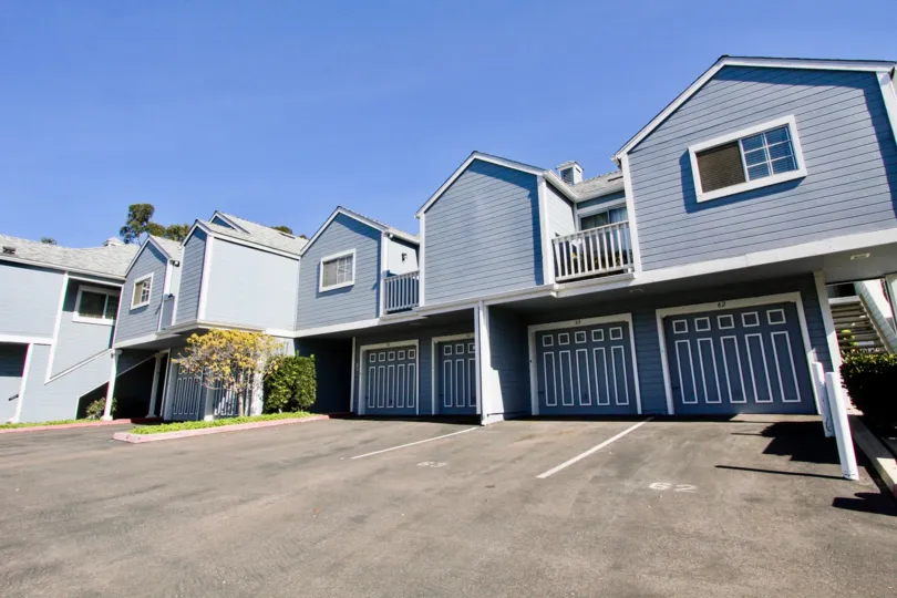 A sunny day in the area of Canyon Colony, outside, parking lot, garages, balconies, condos, stairs