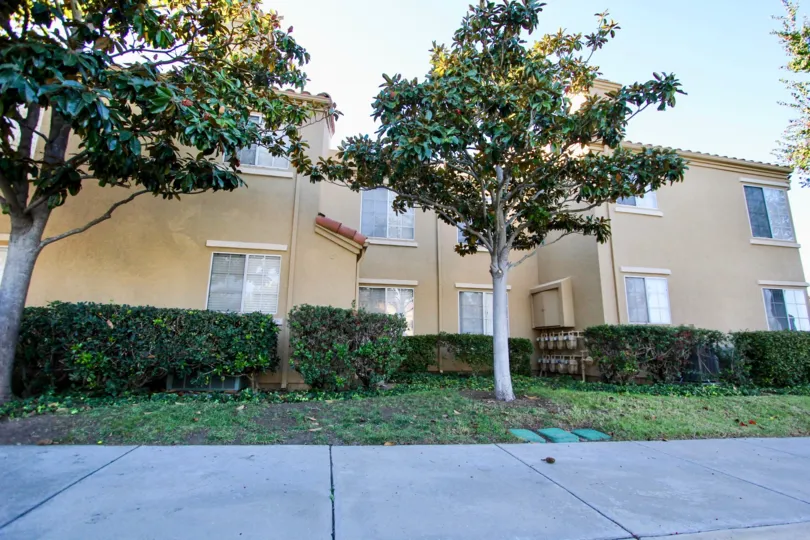 Two story residential building near a sidewalk at Canyon Park Villas in Mira Mesa California