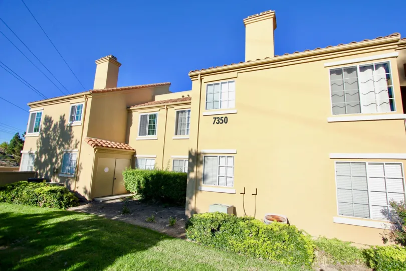 Two story residential units next to green yard at Canyon Park Villas in Mira Mesa California