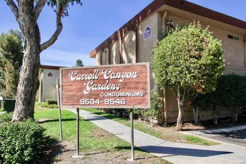 Condo sign in front of two story condos at Carroll Canyon Gardens in Mira Mesa California