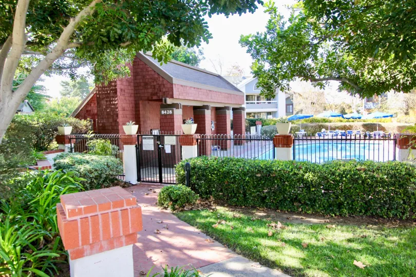 A gardened walkway leads to a gated pool in the Concord Square community of Mira Mesa, California.