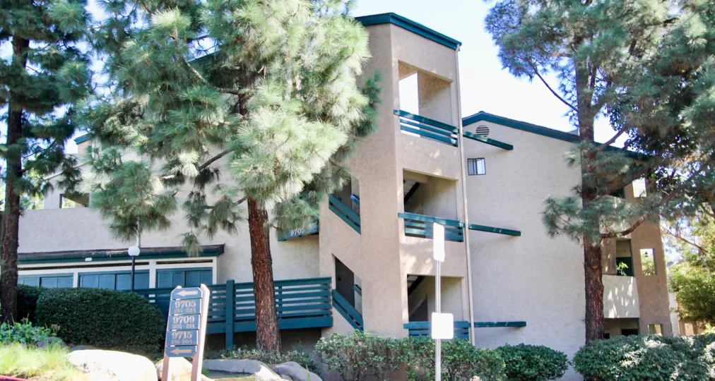 Three story building with trees at Creekside in Mira Mesa California