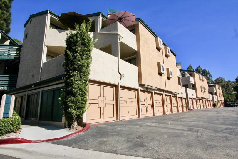 Condominiums with attached garages near a driveway at Creekside in Mira Mesa California