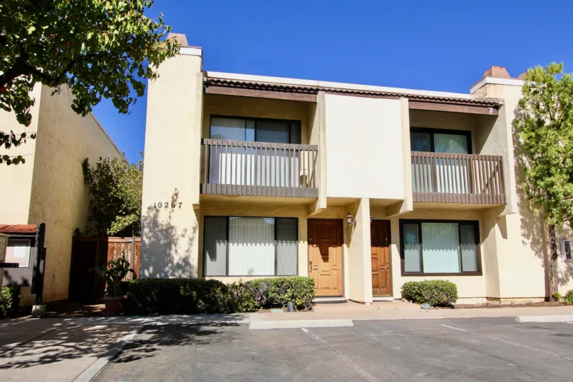 Two apartments and parking spaces, each with their own small balcony.