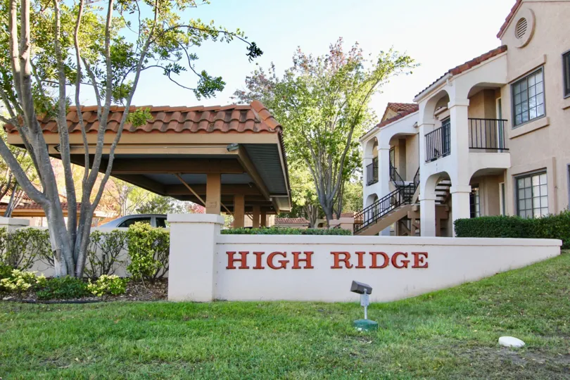 Outside view of Mira Mesa with car shed and garden on a sunny day