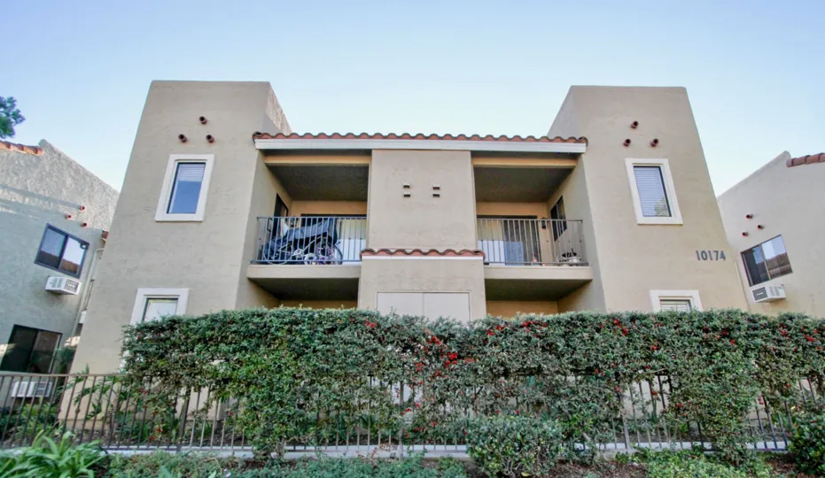 Two story residential units with ivy covered fence at Jade Coast in Mira Mesa California