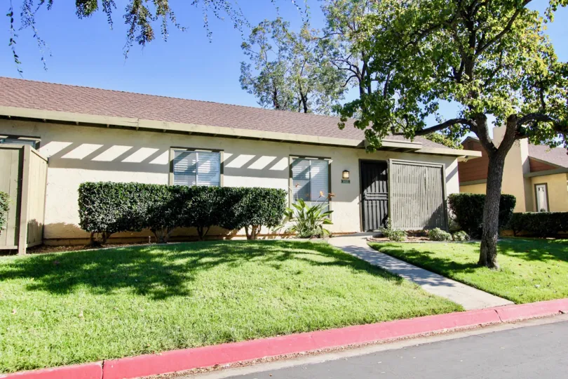 A Beautiful House on a Sunny Day with a green lawn in front in Mesa Village of Mira Mesa