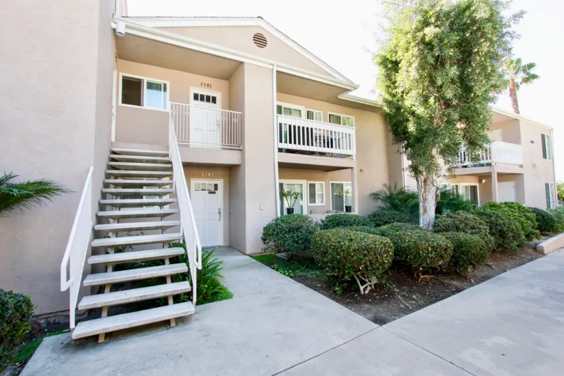 Two story residential building with attached stairway at Mirabella Point in Mira Mesa California
