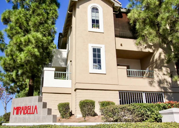 Community sign in front of residential buildings at Mirabella in Mira Mesa California