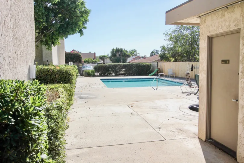 The Monterey Village with a swimming pool and small plants around